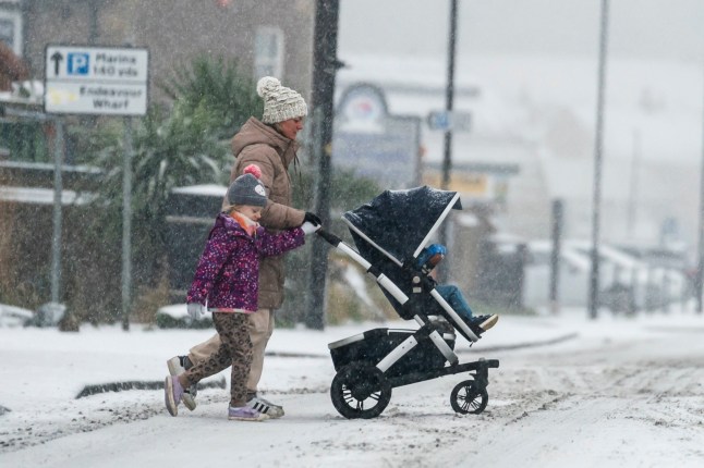 People make their way through snow in Whitby. Hundreds of schools are shut, some for a fourth day, as weather warnings including an amber alert remain in place across many parts of the country. Picture date: Thursday January 18, 2024. PA Photo. Much of the UK endured temperatures below freezing overnight, with preliminary data from the Met Office indicating the mercury fell to as low as minus 11C in England and minus 10C in Scotland. See PA story WEATHER Cold. Photo credit should read: Danny Lawson /PA Wire