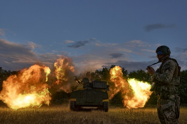 TORETSK DISTRICT, UKRAINE - JULY 31: Soldiers fire a 2C1 "Carnation" - Soviet 122-mm regimental self-propelled artillery installation, the world's first serial floating tracked self-propelled gun on July 31, 2024 in Toretsk district, Ukraine. The Russians are attacking Toretsk daily with artillery, guided air bombs, and FPV drones that fly in the city and hunt for cars. (Photo by Kostiantyn Liberov/Libkos/Getty Images)