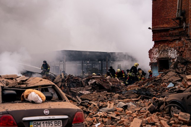 SUMY, UKRAINE - NOVEMBER 26: Firefighters remove debris after Russian missile attack on November 26, 2024 in Sumy, Ukraine. According to the acting mayor of Sumy, Artem Kobzar, the Russian army attacked the city with a missile. As a result of the strike, a residential multi-storey building was damaged and a parking lot was destroyed. (Photo by Pavlo Zarva/Kordon.Media/Global Images Ukraine via Getty Images)