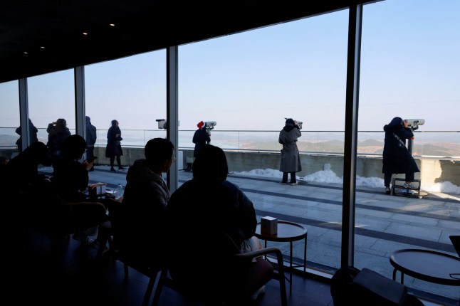 Customers sit in the new store of Starbucks at the top of the Aegibong Peak Observatory, south of the demilitarized zone (DMZ), separating the two Koreas in Gimpo, South Korea, November 29, 2024. REUTERS/Kim Soo-hyeon