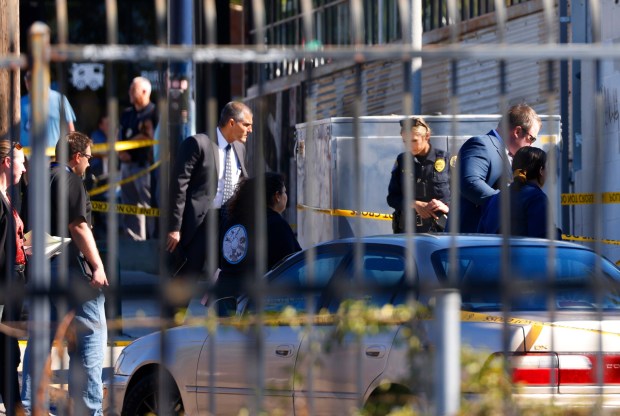 San Diego police investigate a scene were a suspect and Harbor Police officer exchanged gunfire on Juniper Street in Little Italy on Wednesday, Nov. 13, 2024. The suspect was wanted for a prior shooting where two people were shot and killed. (K.C. Alfred / The San Diego Union-Tribune)