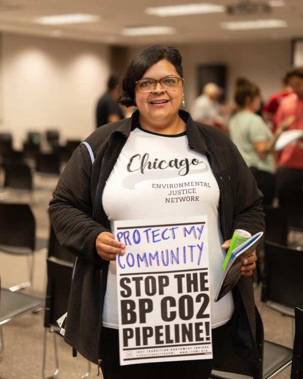 A lady holds a handmade sign that reads, "Stop the BP CO2 Pipeline."