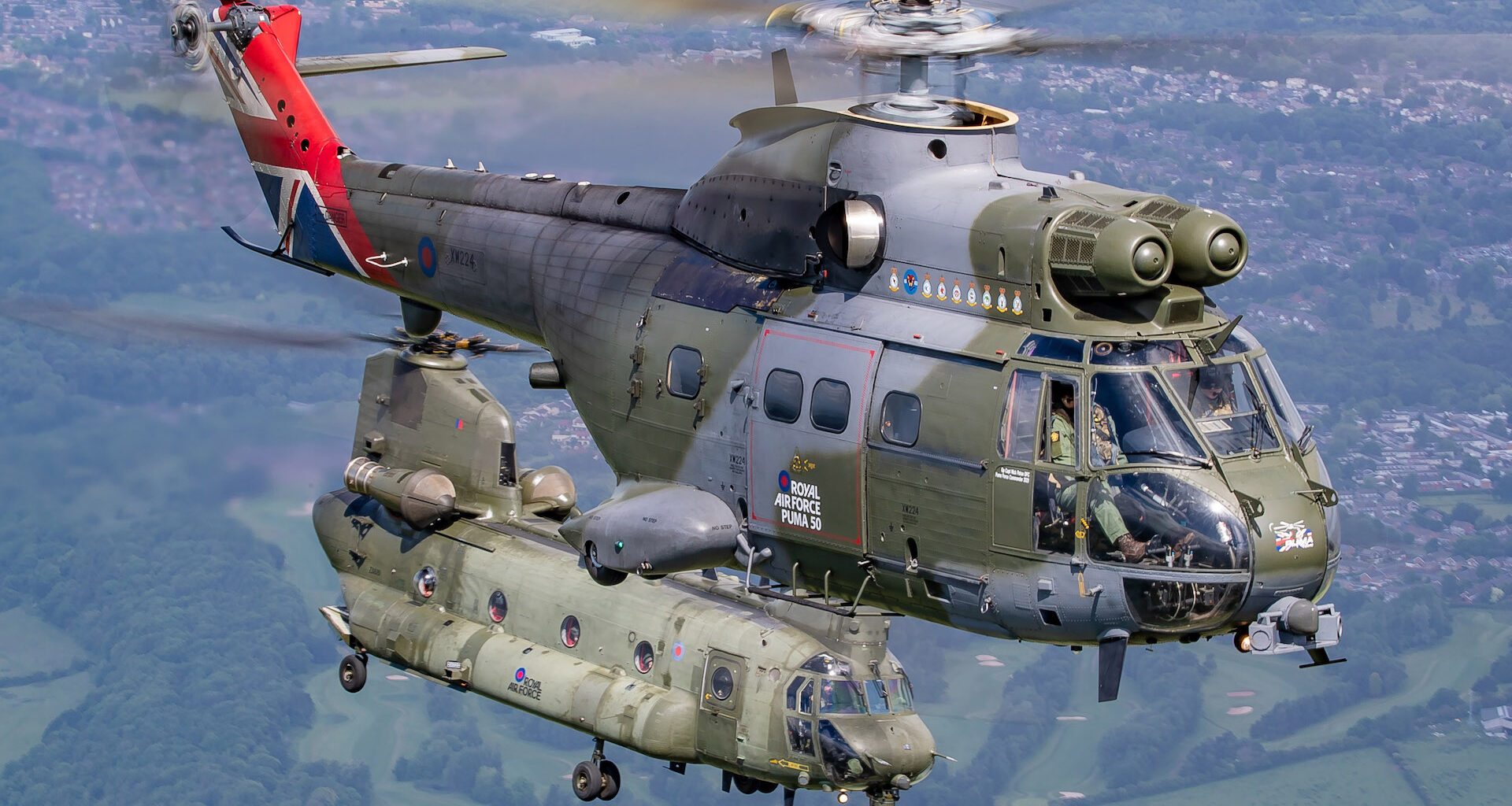 Pictured is an RAF Chinook (27(R) Squadron) flying in formation with a Puma (230 Squadron) over RAF Cosford. After a 3-year Covid-enforced break, the RAF Cosford Air Show will take place on 12 June 2022. The last RAF-organised air show, it attracts 50,000 people to the airfield and incorporates a flying display, static aircraft displays, STEM displays and vintage villages. The highlights of the flying will be the RAF Red Arrows, BBMF, Typhoon display team, Belgian F16 and French Rafale. The RAF F35B displayed at the air show for the first time.