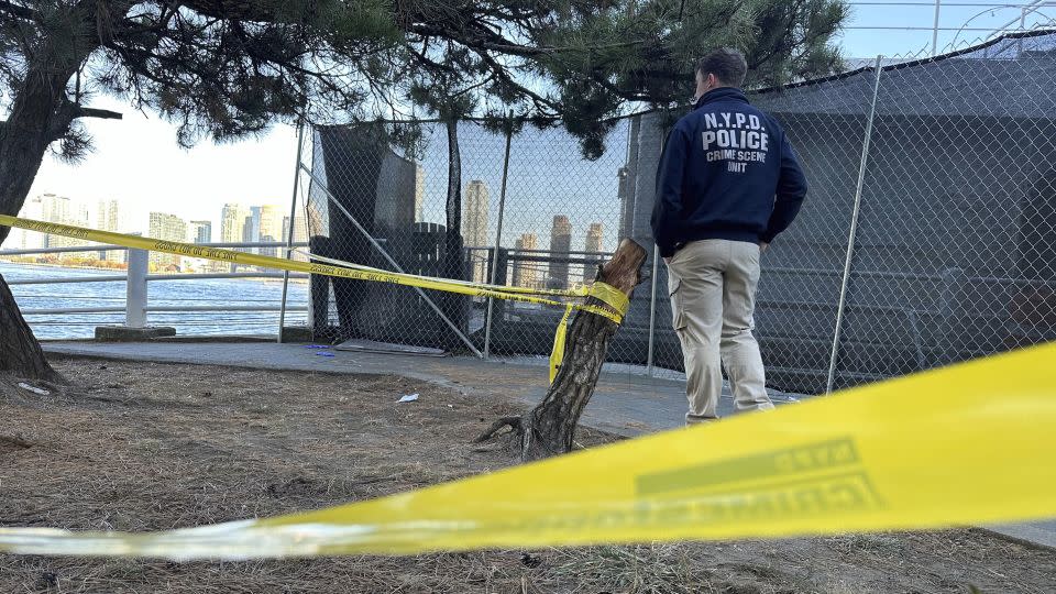 An NYPD officer at the scene of one of Monday's stabbings in New York. - David R. Martin/AP
