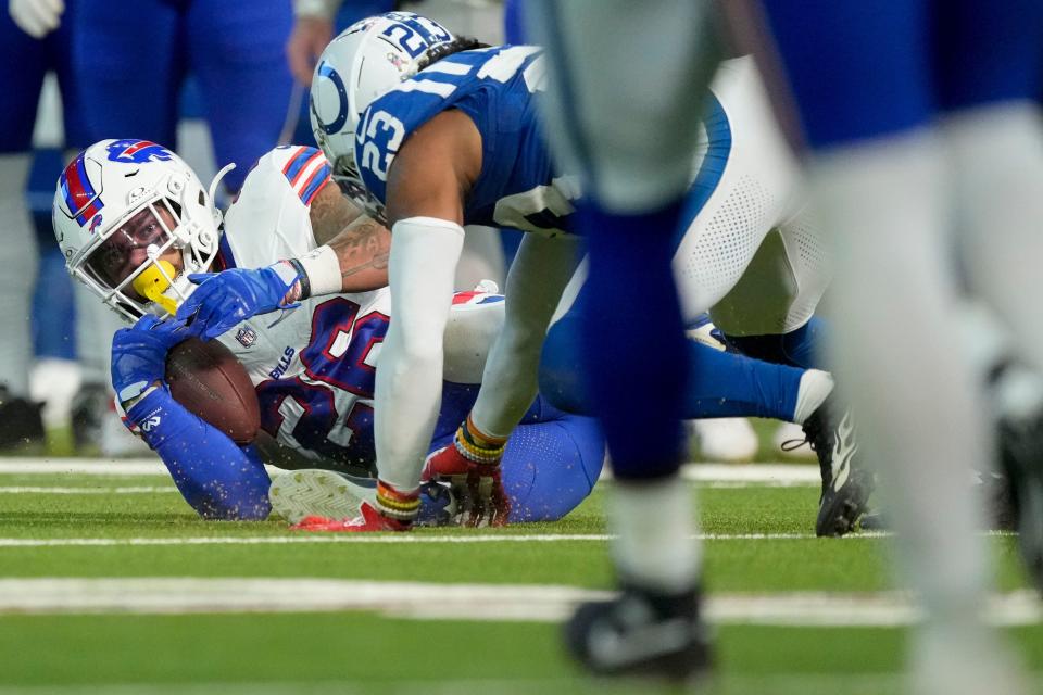 Indianapolis Colts cornerback Kenny Moore II (23) brings down Buffalo Bills running back Ty Johnson (26) on Sunday, Nov. 10, 2024, during a game against the Buffalo Bills at Lucas Oil Stadium in Indianapolis.