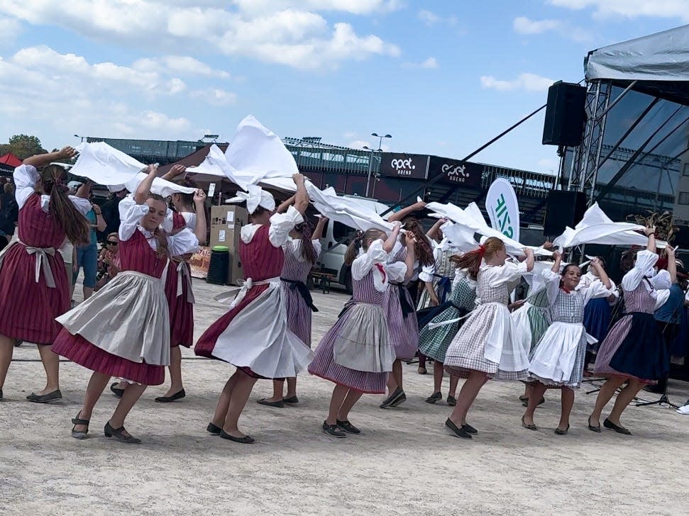 Dancers twirling with white fabric in their hands.