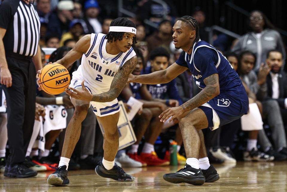 Nov 4, 2024; Newark, New Jersey, USA; Seton Hall Pirates guard Chaunce Jenkins (2) dribbles as St. Peter's Peacocks guard Armoni Zeigler (5) defends during the first half at Prudential Center. Mandatory Credit: Vincent Carchietta-Imagn Images