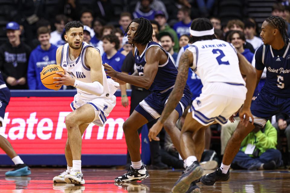 Nov 4, 2024; Newark, New Jersey, USA; Seton Hall Pirates forward Yacine Toumi (9) is guarded by St. Peter's Peacocks center Jaquel Morris (21) during the first half at Prudential Center. Mandatory Credit: Vincent Carchietta-Imagn Images