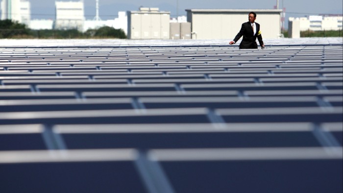 A man walks between the panels