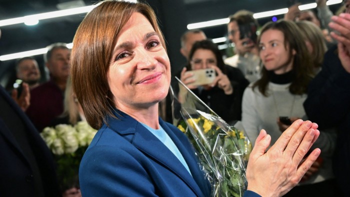 Moldova’s President Maia Sandu clapping her hands with staff and supporters following preliminary results of the second round of the presidential election