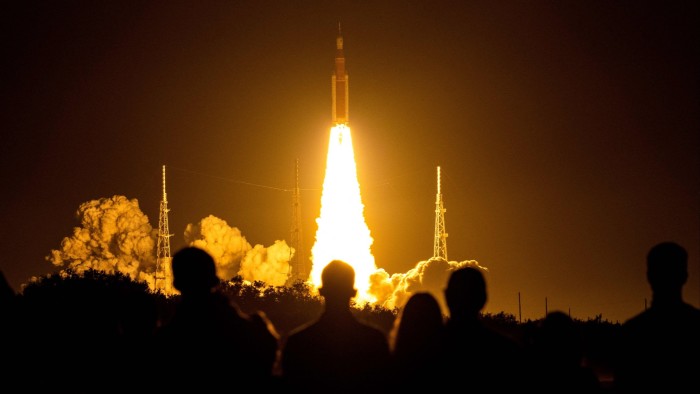 Spectators watch as the Artemis I unmanned lunar rocket lifts off from NASA’s Kennedy Space Center in Cape Canaveral, Florida, on November 16 2022