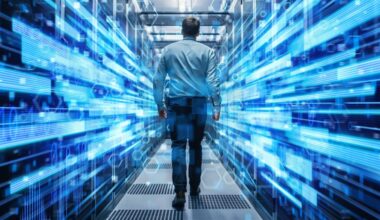 Shot of a Young It Specialist Walking through Corridor in Working Data Center Full of Rack Servers and Supercomputers. Conceptual Visualisation of High Speed Internet Connection with Digits and Lines. — Photo