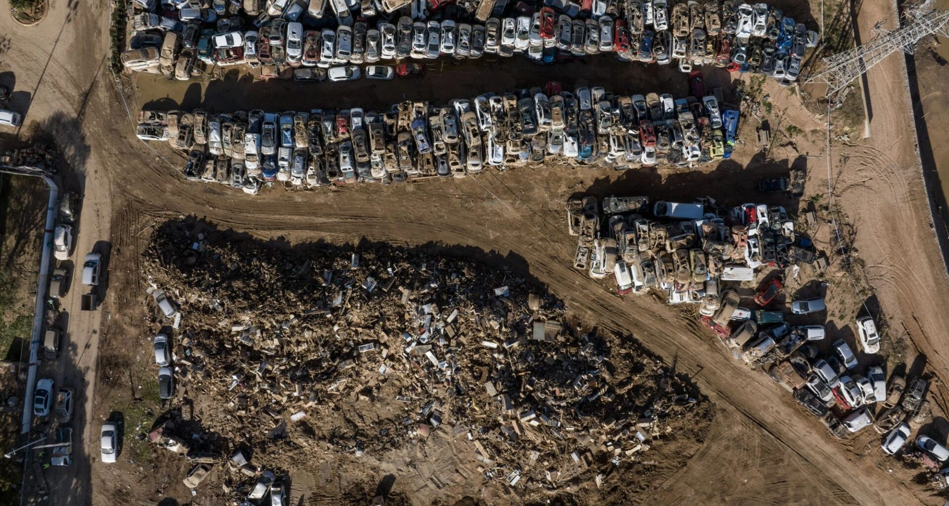 Horror pics show car graveyard in Spain with piles of wrecked & mud-caked motors after floods that killed more than 200