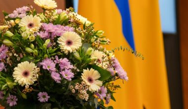 Flowers with Ukrainian flag at Latvian Saeima