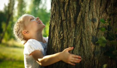 Child hugging tree