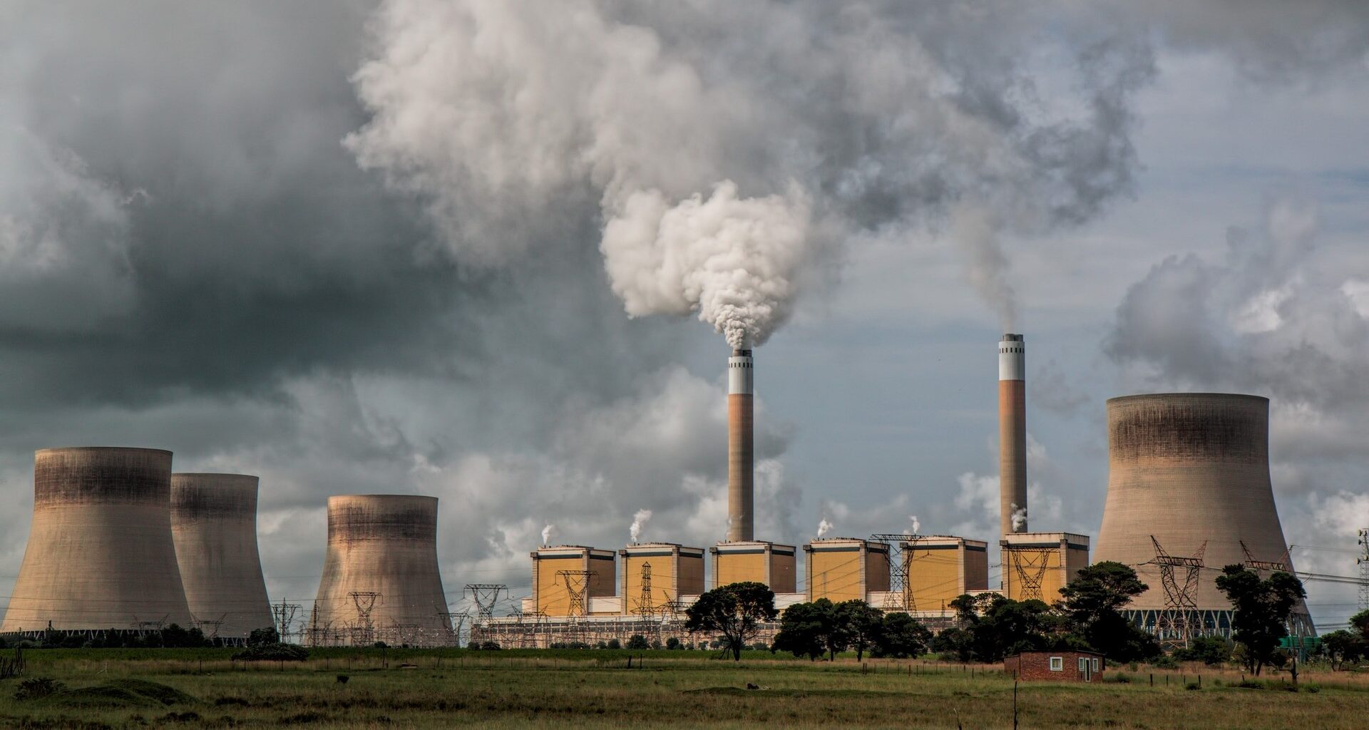A power station, with chimneys releasing smoke