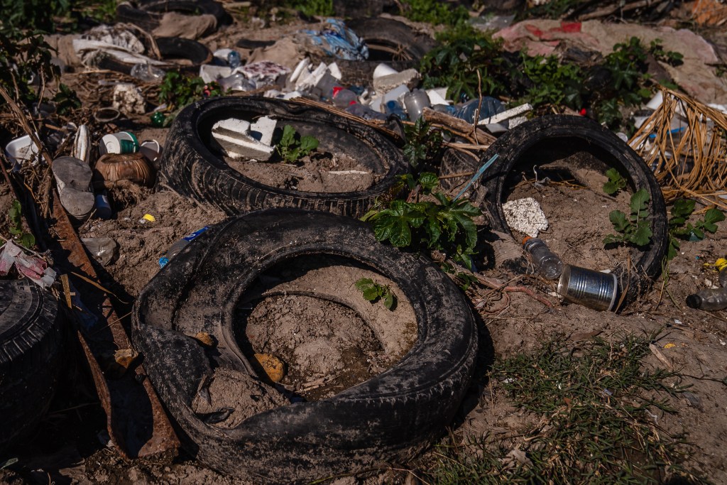 Tires and trash in the Tijuana River Valley on Dec. 20, 2022.