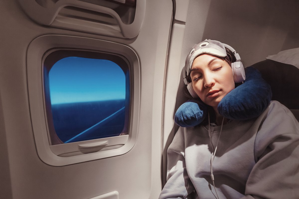 Woman sleeping on plane.