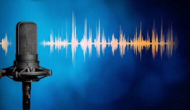 Professional studio microphone on blue background with orange audio waveform, Podcasting, broadcasting or recording studio banner