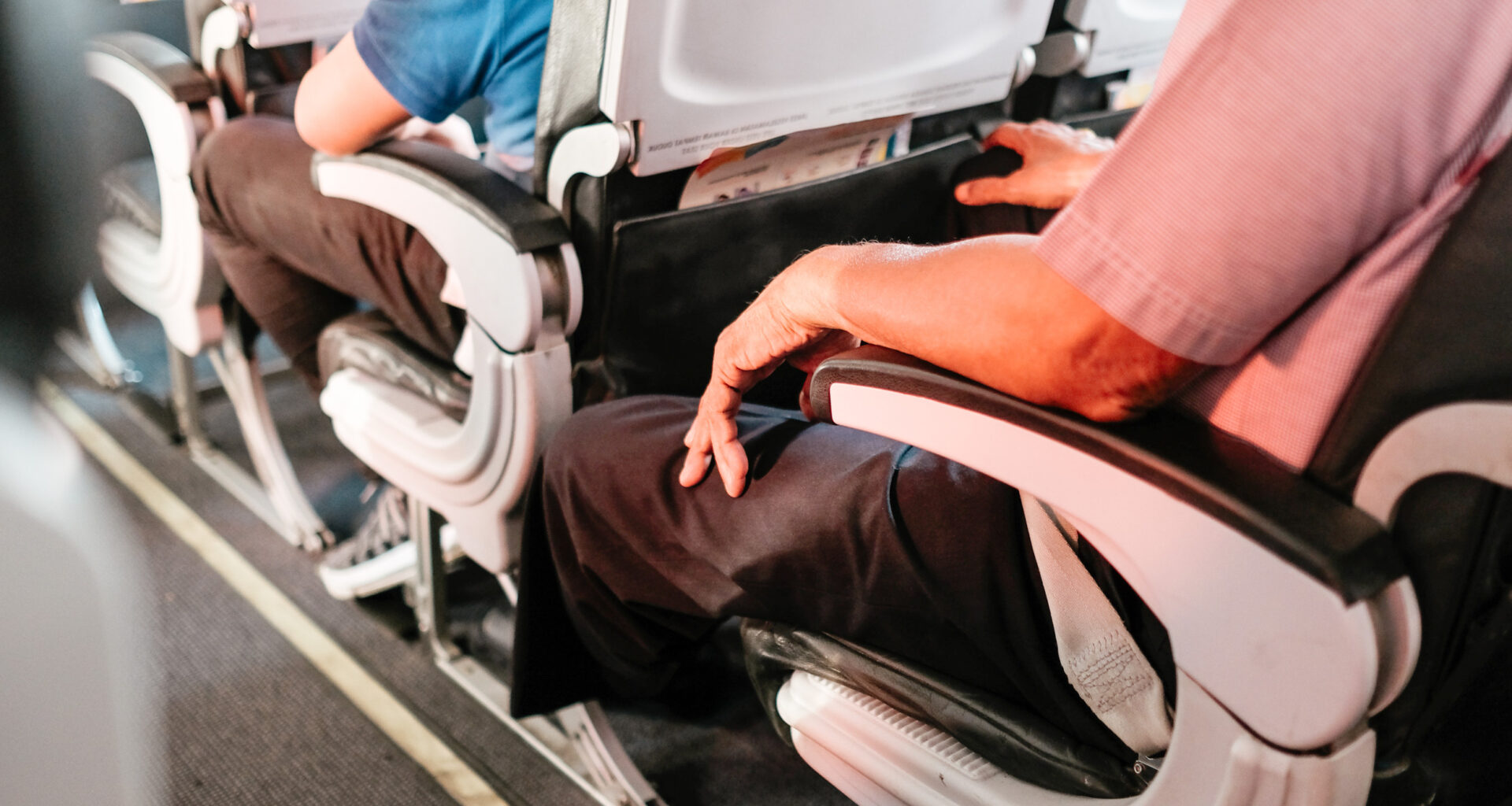 Passengers seated on a plane.