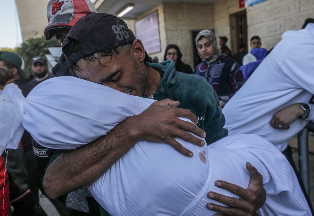 Mohammed Abu Saied holding and mourning the body of his four-year-old daughter Sila at Al-Aqsa Martyrs hospital in Deir Al Balah, central Gaza Strip, following an Israeli airstrike.