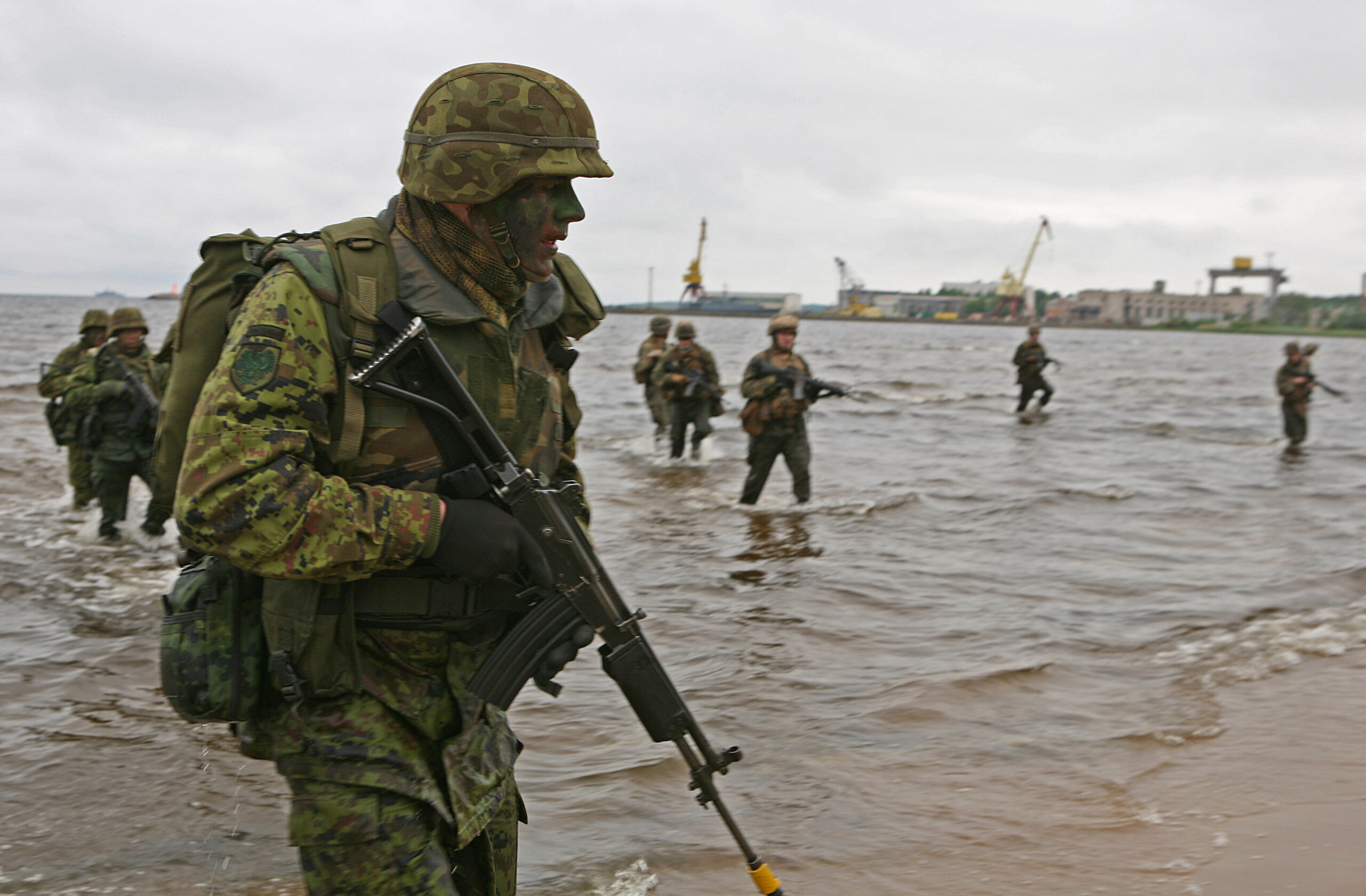 Estonian soldiers and U.S. Marines wade ashore during a combined U.S., Estonian amphibious landing at a beach here. The combined training demonstration was part Baltic Operations 2010, an exercise designed to increase the interoperability of NATO and partner nations in the Baltic Sea region.
