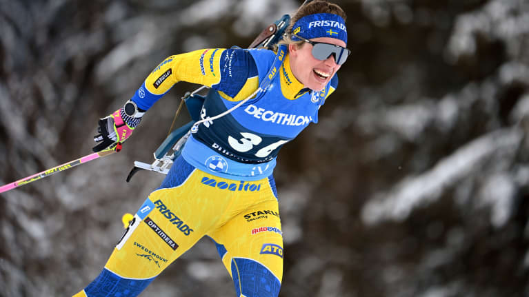 Elvira Öberg hiihtää metsässä.