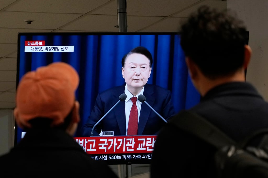 People watch a TV screen showing South Korean President Yoon Suk-yeol’s televised briefing at a bus terminal in Seoul, South Korea on December 3. Photo: AP People watch a TV screen showing South Korean President Yoon Suk-yeol’s televised briefing at a bus terminal in Seoul, South Korea on December 3. Photo: AP