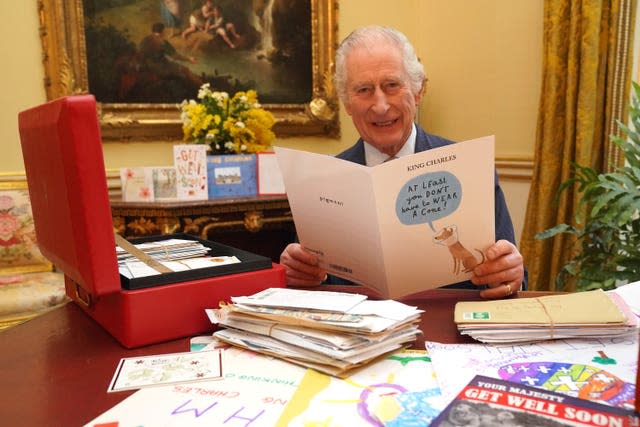 The King reads cards and messages, sent by well-wishers, following his cancer diagnosis