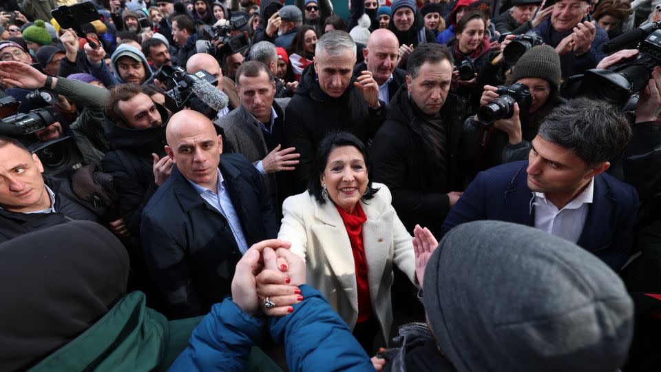 Georgia's outgoing pro-EU President Salome Zurabishvili (center) condemned her anti-Western successor, telling supporters on Sunday: “I am taking legitimacy with me." - Giorgi Arjevanidze/AFP/Getty Images