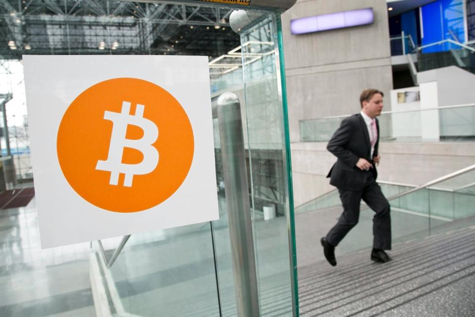 FILE - In this April 7, 2014 file photo, a man arrives for the Inside Bitcoins conference and trade show in New York. An Australian man long thought to be associated with the digital currency Bitcoin has publicly identified himself as its creator. BBC News said Monday, May 2, 2016 that Craig Wright told the media outlet he is the man previously known by the pseudonym Satoshi Nakamoto. The computer scientist, inventor and academic says he launched the currency in 2009 with the help of others.