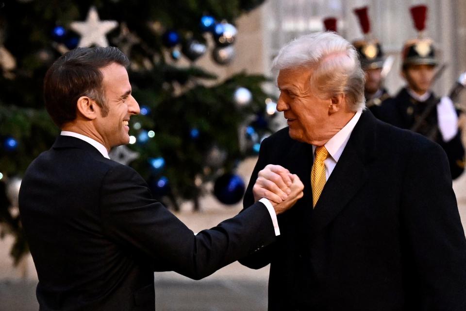 France's President Emmanuel Macron (L) shakes hands with US president-elect Donald Trump (R) as he welcomes him ahead of a meeting at the Elysee Presidential Palace in Paris on December 7, 2024.