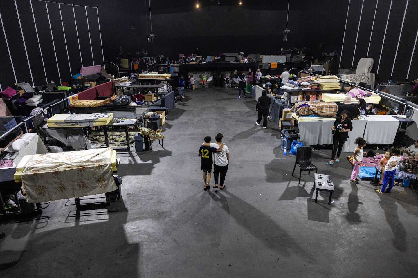 Lebanese families displaced by Israel’s bombing campaign against Hezbollah took shelter inside the Skybar nightclub in Beirut on Oct. 9.