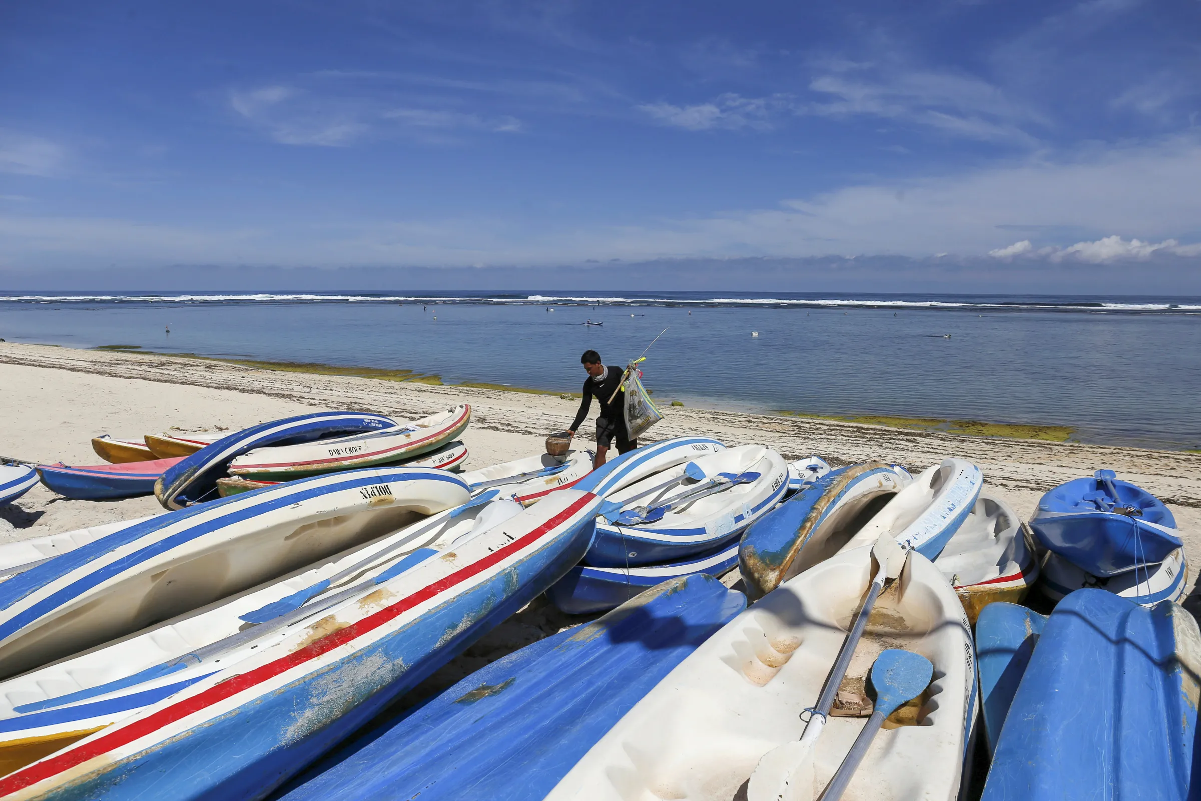 A fisherman prepares to fish at Pandawa Beach in South Kuta, Bali, Indonesia March 23, 2020. REUTERS/Johannes P. Christo