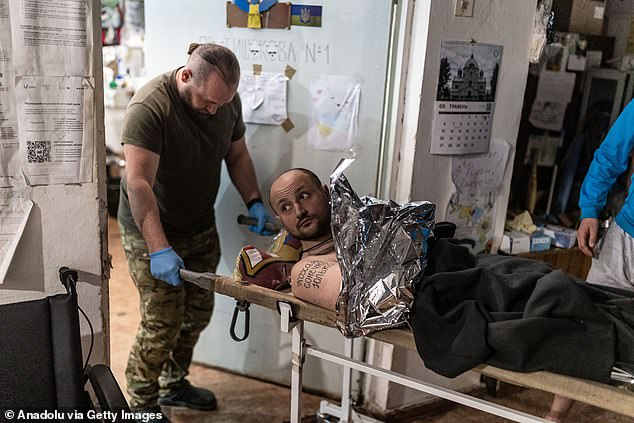 Ukrainian medics transfer a wounded Ukrainian soldier to a stabilisation point in the direction of Siversk-Soledar, 11 May 2024