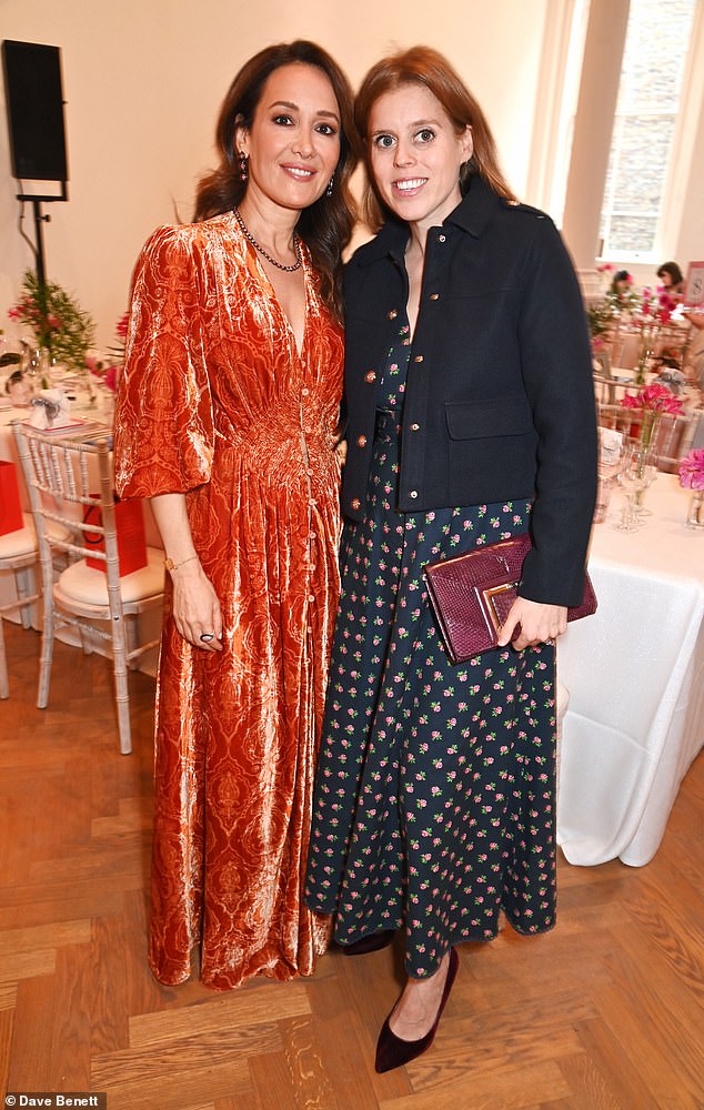 Beatrice donned a black floral print dress, adorned with roses, teamed with a navy blazer decorated by golden buttons. Pictured with Batia Ofer