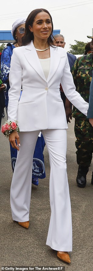She was immaculately clad in a figure-skimming white suit by Altuzarra while visiting Nigeria