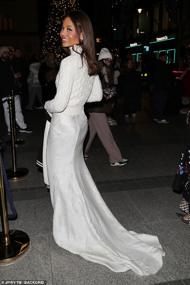 Emma Weymouth wore a beautiful white silk skirt complete with a dramatic train, which she paired with a cropped, cable knit sweater
