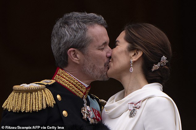 King Frederik X of Denmark kisses Queen Mary of Denmark on the balcony of Christiansborg Palace in Copenhagen, Denmark on January 14, 2024, after a declaration on the accession to the throne by the Danish prime minister