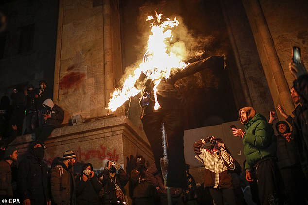 Georgian opposition supporters burn effigy of Georgian Prime Minister Kobakhidze, during a protest in front of the Parliament building in Tbilisi, Georgia, 30 November 2024