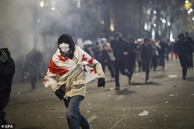 Police use tear gas to disperse Georgian opposition supporters protesting in front of the Parliament building in Tbilisi, Georgia, 30 November 2024