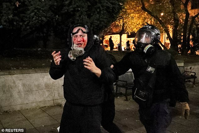 Police officers escort a demonstrator during a rally of opposition parties' supporters, who protest against the new government's decision to suspend the European Union accession talks and refuse budgetary grants until 2028, in Tbilisi, Georgia November 30, 2024