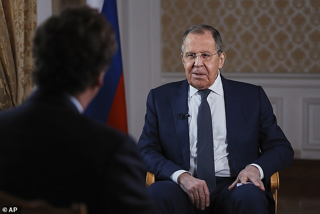 Russia's Foreign Minister Sergey Lavrov, speaks during an interview with former Fox News host Tucker Carlson, back to a camera, in Moscow, Russia on Tuesday, Dec. 3, 2024