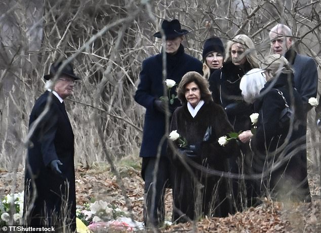 Queen Silvia and attendees carried a single white rose during Princess Birgitta's burial at the Royal Cemetery in Hagaparken