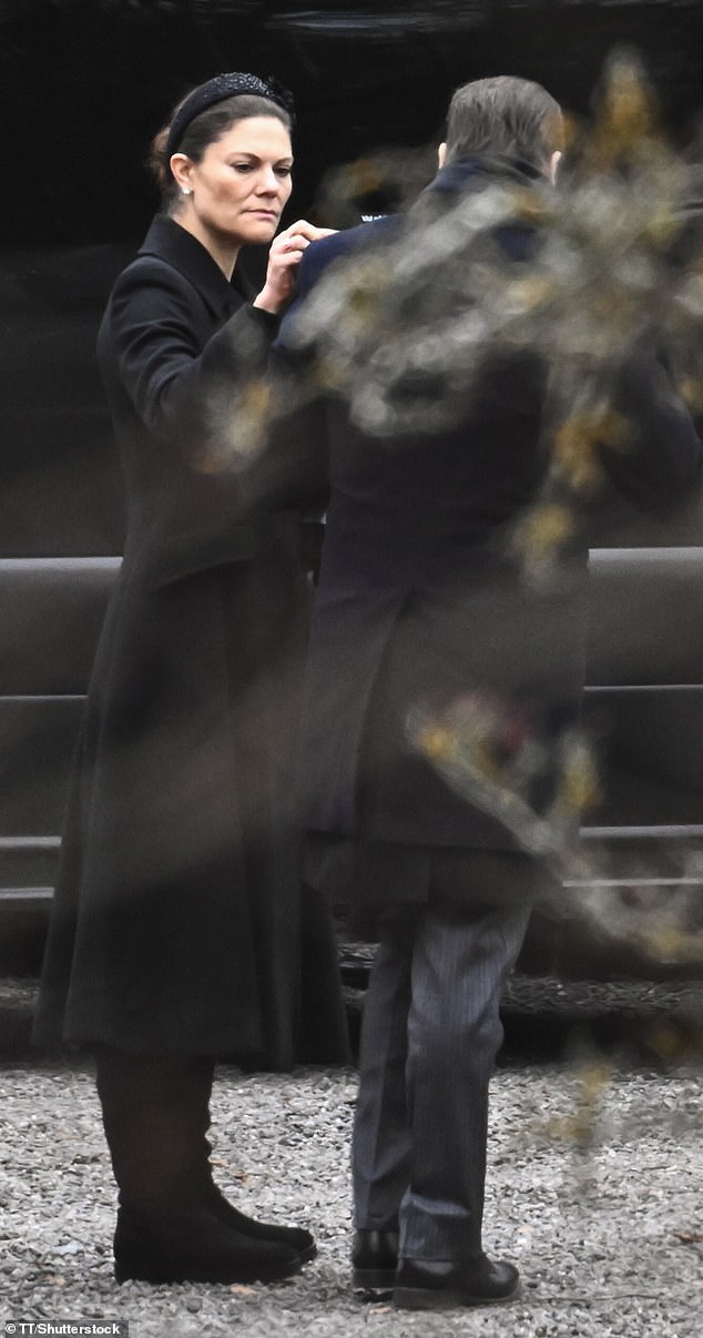 Crown Princess Victoria dutifully picked lint off of Prince Daniel's coat outside the Royal Cemetery