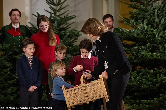 Prince Julian, Silvia's youngest grandchild, is known for being a little mischievous at royal events, but he seemed to be on his best behaviour in a bid to make Santa's good list. Here, he can be seen examining the sparkly baubles in Queen Silvia's basket