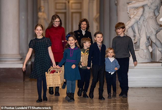 Queen Silvia spent Monday evening decorating the Royal Palace's Christmas trees with her grandchildren. From left to right: Princess Leonore, Princess Estelle, Princess Adrienne, Queen Silvia, Prince Gabriel, Prince Oscar, Prince Julian and Prince Nicolas