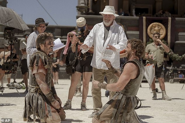 This image released by Paramount Pictures shows Pedro Pascal, from left, director Ridley Scott, and Paul Mescal on the set of Gladiator 2