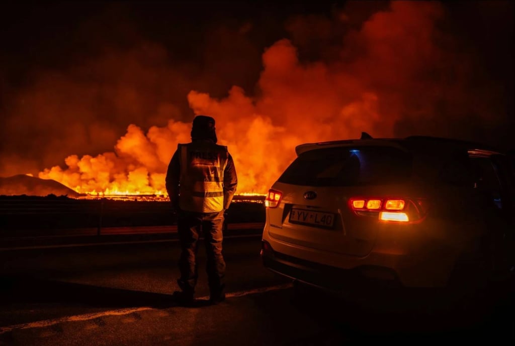 A member of the press watches lava after a volcanic eruption. Photo: AP A member of the press watches lava after a volcanic eruption. Photo: AP
