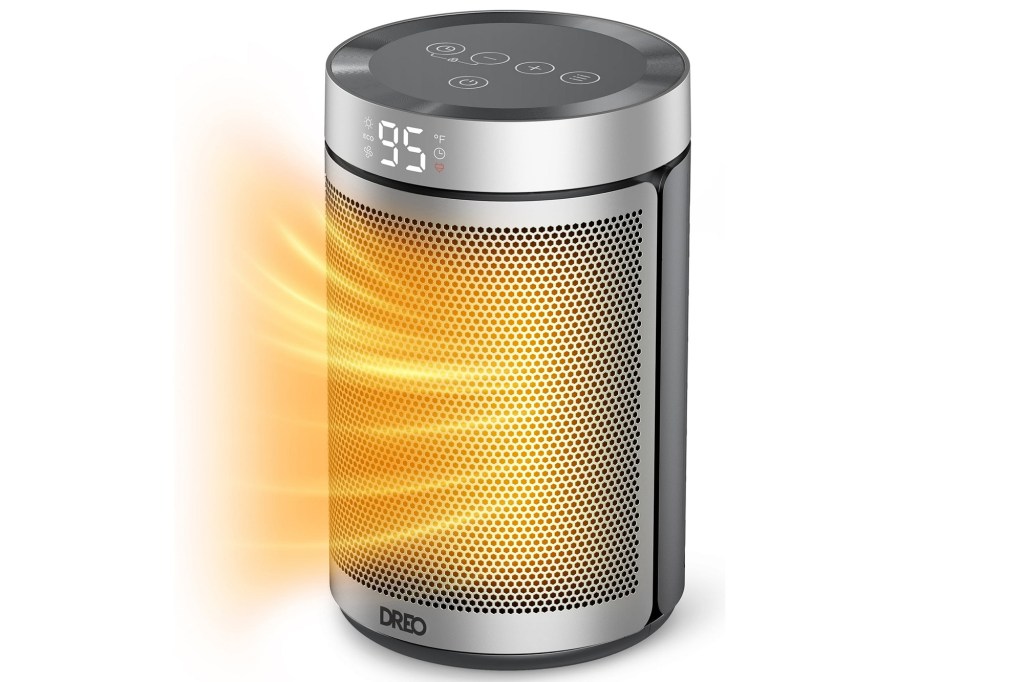 Round black and silver space heater with a glowing yellow light